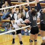 Homers Laura Inama hits over Soldotnas Bethany Richmond (10) and Jolie Widaman during a Tuesday, Sept. 22, 2020 volleyball game in the Alice Witte Gymnasium in Homer, Alaska. (Photo by Megan Pacer/Homer News)