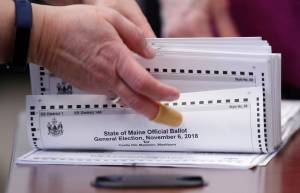 In this Nov. 12, 2018 file photo, ballots are prepared to be tabulated in Maines 2nd Congressional District election in Augusta, Maine. Alaskas Measure 2 would change the states voting system to a ranked-choice voting system like the one used in Maine, among other election reforms. (Robert F. Bukaty/Associated Press)