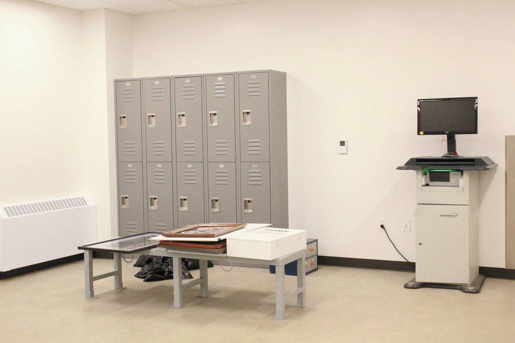 Lockers and a fingerprinting machine sit in the intake area for inmates in the jail portion of the new Homer Police Station, seen here on Thursday, Sept. 24, 2020 in Homer, Alaska. Unlike in the previous station, the cell block area is completely separated from the administrative side of the building. (Photo by Megan Pacer/Homer News)