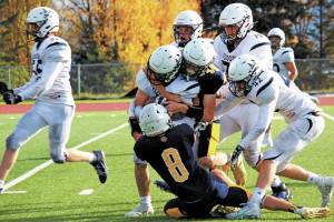 Homers Sly Gaona (No. 8) and Nestor Kalugin (No. 48) tackle Soldotnas Austin Escott during a Saturday, Oct. 3, 2020 football game at Homer High School in Homer, Alaska. (Photo by Megan Pacer/Homer News)