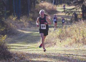 Kenai Centrals Jayna Boonstra runs to victory at the Region III/Southern Division meet Saturday, Oct. 3, 2020, at Tsalteshi Trails near Soldotna, Alaska. (Photo by Jeff Helminiak/Peninsula Clarion)