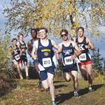 Homers Lance Seneff leads the pack in the first kilometer of the Region III/Southern Division boys race Saturday, Oct. 3, 2020, at Tsalteshi Trails just outside of Soldotna, Alaska. Race champion Maison Dunham of Kenai Central is at far right. (Photo by Jeff Helminiak/Peninsula Clarion)