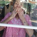Kisses Through the Window, a photo taken by Jamee Schleifer on May 5, 2020, in Brooklyn, New York, of her grandmother, Joyce Arberman, is one of the images submitted to Christina Whitings Behind the Mask - Our Stories project. (Photo by Jamee Schleifer; courtesy Christina Whiting)
