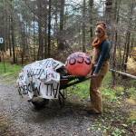 Sarah Brewer moves some props for Haunted Shakespeare in a photo taken Oct. 12, 2020, at the Pratt Museum forest trail in Homer, Alaska. Brewer is the curator and director of the evening of theater. (Photo courtesy Pier One Theatre)