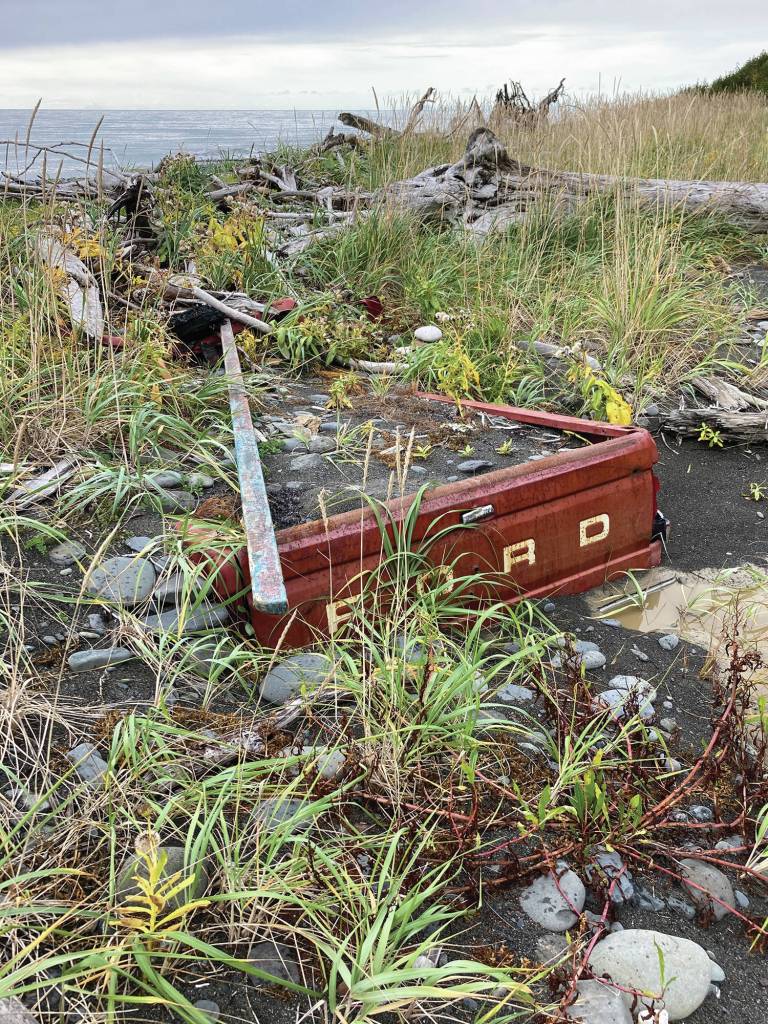 Since being abandoned in 2011 on the Diamond Creek beach near Homer, Alaska, mud and gravel pushed in by storms has almost buried this Ford pickup truck, as seen here on Sunday, Oct. 4, 2020. (Photo by Michael Armstrong/Homer News)