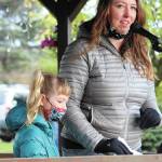 Irene Sexton speaks with her daughter at her side during a rally to commemorate Ruth Bader Ginsburg and protest swift action to replace her on the Supreme Court on Saturday, Oct. 17, 2020 at WKFL Park in Homer, Alaska. (Photo by Megan Pacer/Homer News)