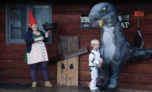Eve Dickman hands out candy at the home of Sean and Sandra Perry for Halloween on Oct. 31, 2019, in Homer, Alaska. (Photo by Michael Armstrong/Homer News)