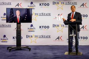 Al Gross, right, an independent in Alaskas U.S. Senate race, holds a document during a debate with Republican U.S. Sen. Dan Sullivan last Friday, in Anchorage. Sullivan participated remotely, as the Senate prepares to vote on President Donald Trumps Supreme Court nominee in Washington. (Jeff Chen / Alaska Public Media)