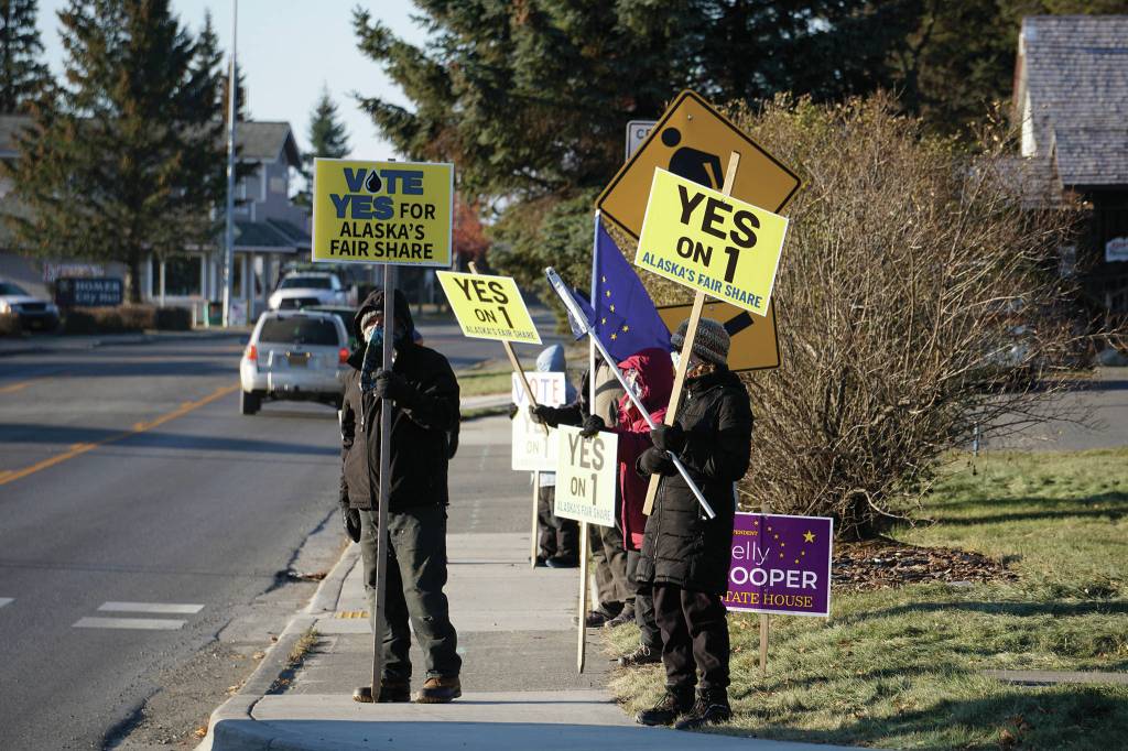 Supporters of Alaska Ballot Measure 1 wave signs urging a yes vote on Tuesday, Nov. 3, 2020, on Pioneer Avenue in Homer, Alaska. Ballot Measure 1 seeks to change the tax structure for some Alaska oil and gas production. (Photo by Michael Armstrong/Homer News)