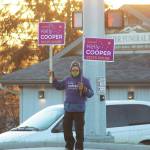 A supporter holds signs for Alaska House of Representatives District 31 candidate Kelly Cooper at the corner of Main Street and the Sterling Highway on Tuesday, Nov. 3, 2020 in Homer, Alaska. (Photo by Megan Pacer/Homer News)