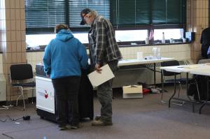 A poll worker helps a voter with his ballot at the Soldotna Regional Sports Complex on Tuesday, Nov. 3 in Soldotna, Alaska. (Photo by Ashlyn OHara/Peninsula Clarion)