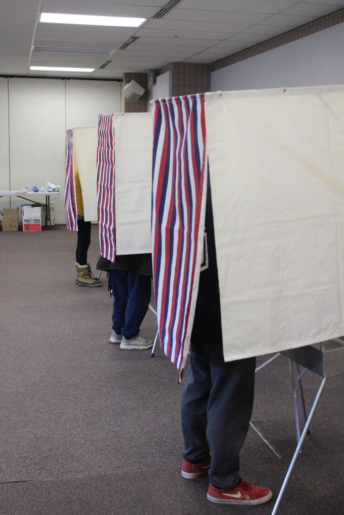 Voters fill out ballots in voting booths at the Soldotna Regional Sports Complex on Tuesday, Nov. 3 in Soldotna, Alaska. (Photo by Ashlyn OHara/Peninsula Clarion)