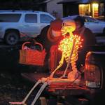 Carol Standaert hands out candy on Halloween night, Oct. 31, 2020, in downtown Homer, Alaska. Trick or treating was more subdued than usual, but still drew children in costume to neighborhood above Pioneer Avenue. (Photo by Michael Armstrong/Homer News)