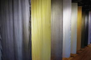 A row of dyed silk wall hangings shows how common Alaska plants found on the lower Kenai Peninsula can be used to make organic dyes, as seen here on Tuesday, Nov. 10, 2020. The hangings are included in Elissa Pettibone's exhibit, "Swatches," showing at Bunnell Street Arts Center in Homer, Alaska. (Photo by Michael Armstrong/Homer News)