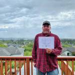 Hero of the Heart Gregory Drais holds his award from South Peninsula Haven House in this photo taken July 25, 2020, in Homer, Alaska. (Photo courtesy South Peninsula Haven House)