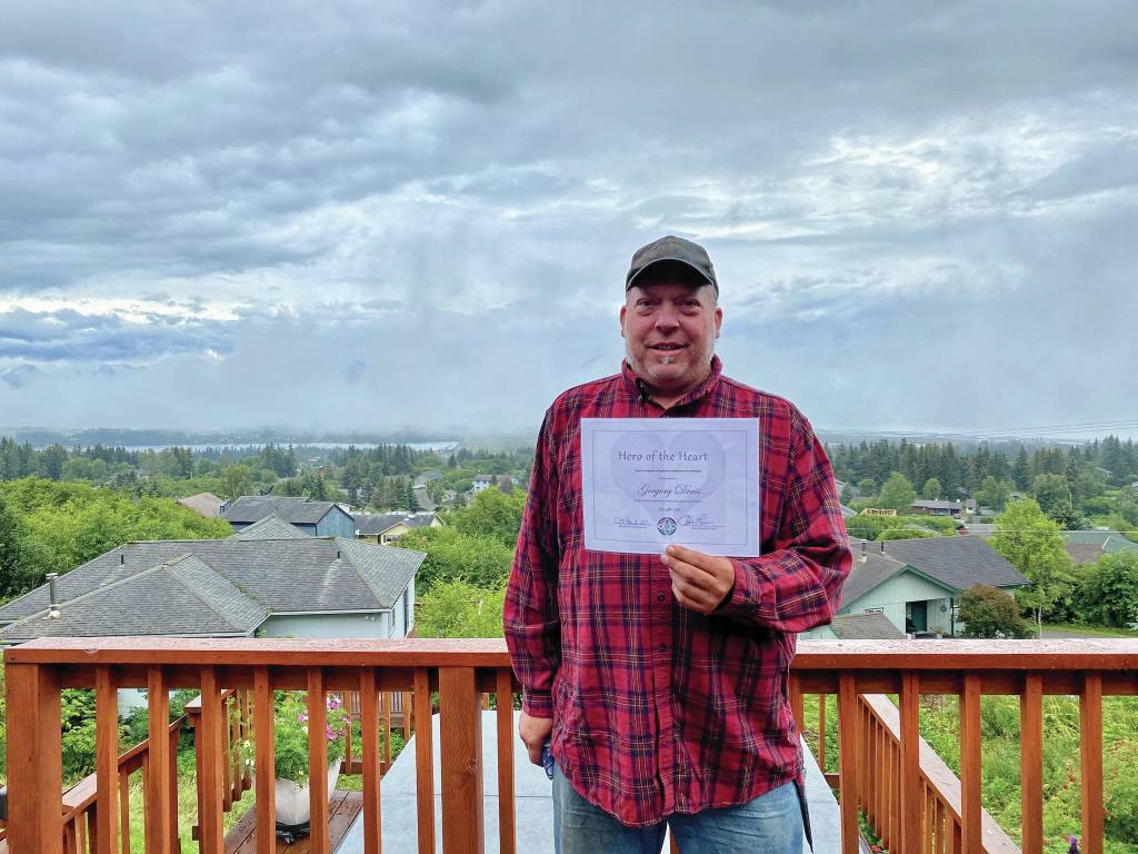 Hero of the Heart Gregory Drais holds his award from South Peninsula Haven House in this photo taken July 25, 2020, in Homer, Alaska. (Photo courtesy South Peninsula Haven House)