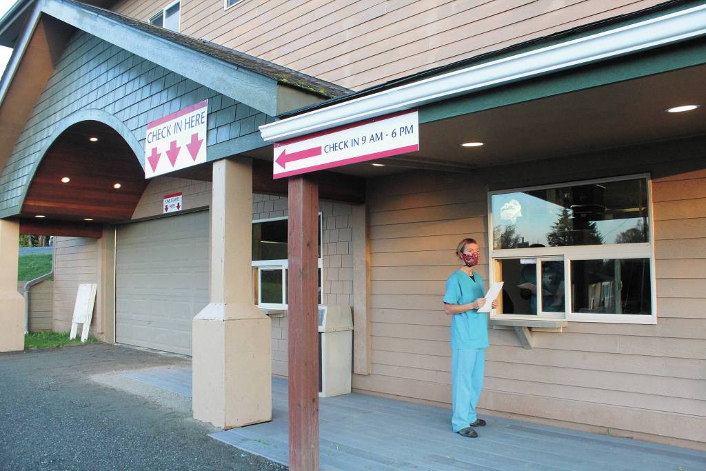 Registered Nurse Annie Garay puts the finishing touches on South Peninsula Hospitals new COVID-19 testing site, located at the lower level of the hospitals specialty clinic at 4201 Bartlett Street, on Tuesday, Oct. 6, 2020 in Homer, Alaska. Its a self-swab site where people register at one window, and collect a swab kit from a nurse at another window. (Photo by Megan Pacer/Homer News)