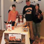 Anna Godfrey (center) signs her National Letter of Intent to row at Oregon State University, with her mother Paula (left), father Dave (second from right) and sister Grace (right). (Photo credit Henry Freund)