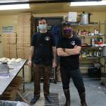 Pizza Underground owner Ethan Eutsler, right, and coworker Jack Pierre, left, take a break from making pizza dough on Tuesday, Dec. 1, 2020, the opening day of the business, in the basement of Alices Champagne Palace in Homer, Alaska. (Photo by Michael Armstrong/Homer News)