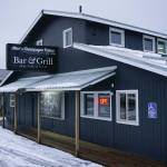 Rain and snow fall on Alices Champagne Palace on Tuesday, Dec. 1, 2020, in Homer, Alaska. The iconic bar on Pioneer Avenue is the site of Pizza Underground, located in the basement. (Photo by Michael Armstrong/Homer News)