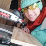 Kim Schuster poses with her scroll saw in a photo taken in November 2019 at her Homer, Alaska, workshop. (Photo courtesy Kim Schuster)