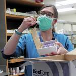 South Peninsula Pharmacist Jill Kort examines a vial of the Pfizer vaccine for COVID-19 shortly after it arrived at the hospital on Wednesday, Dec. 16, 2020 in Homer, Alaska. (Photo by Megan Pacer/Homer News)