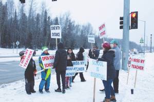 Protestors are seen at the intersection of Kenai Spur Hwy. and Sterling Hwy. on Tuesday, Dec. 15, 2020 in Soldotna, Alaska. (Photo by Ashlyn OHara/Peninsula Clarion)