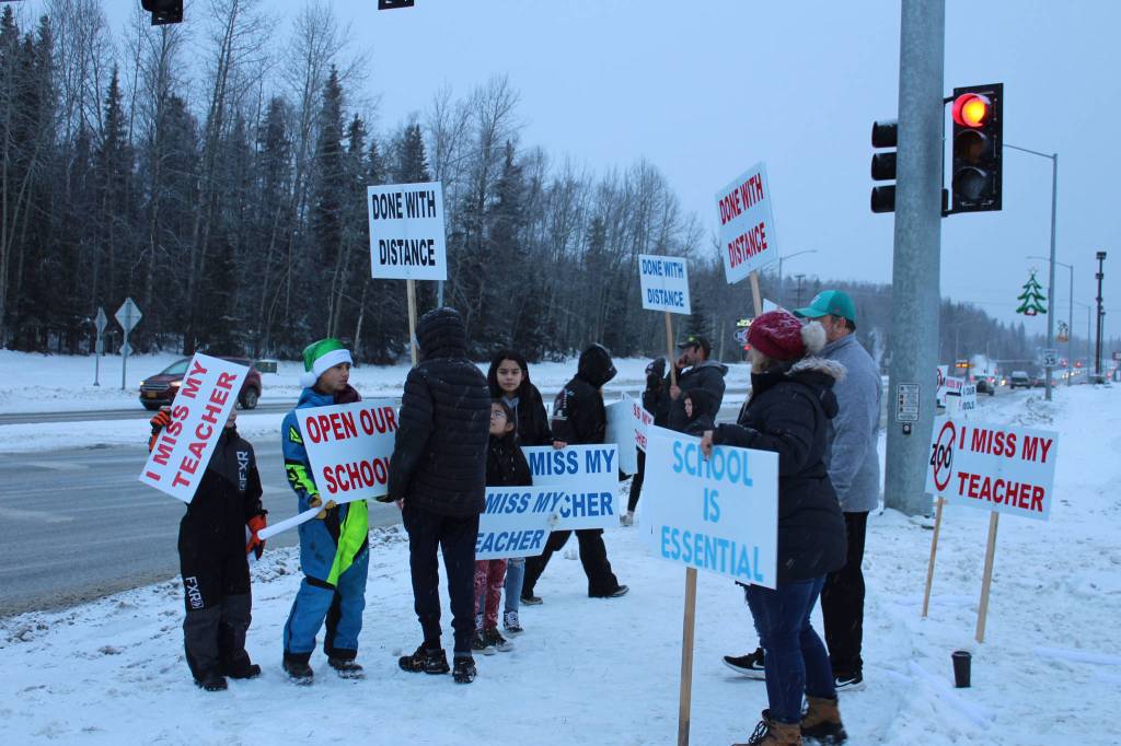 Protestors are seen at the intersection of Kenai Spur Hwy. and Sterling Hwy. on Tuesday, Dec. 15, 2020 in Soldotna, Alaska. (Photo by Ashlyn OHara/Peninsula Clarion)