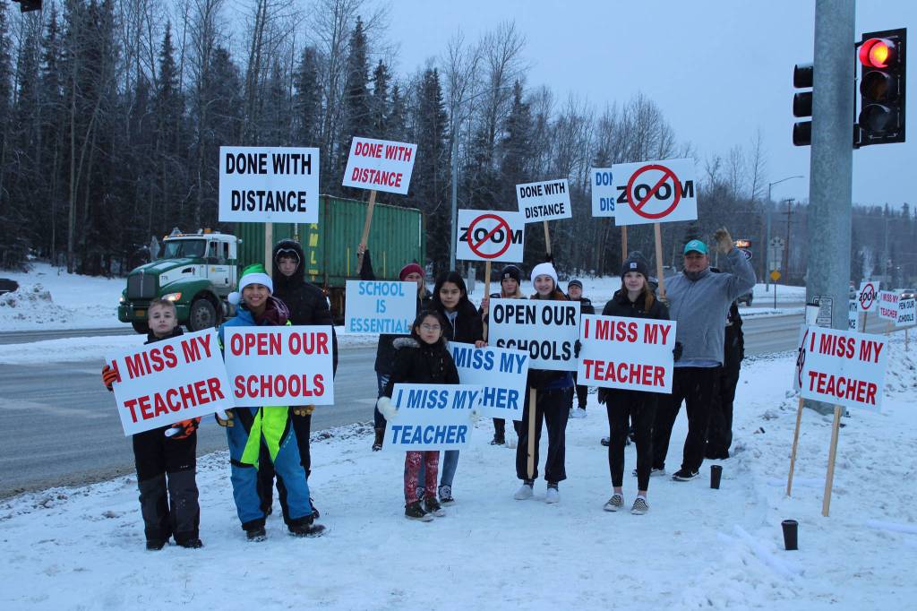 Protestors are seen at the intersection of Kenai Spur Hwy. and Sterling Hwy. on Tuesday, Dec. 15, 2020 in Soldotna, Alaska. (Photo by Ashlyn OHara/Peninsula Clarion)