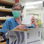 South Peninsula Pharmacist Jill Kort unpacks the Pfizer vaccine for COVID-19 shortly after it arrived at the hospital on Wednesday, Dec. 16, 2020 in Homer, Alaska. (Photo by Megan Pacer/Homer News)