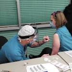 Family practice physician Christina Tuomi, DO, (right) gets Homers first dose of Pfizers COVID-19 vaccine from Emergency Department nurse Steve Hughes (left) on Thursday, Dec. 17, 2020 at South Peninsula Hospital in Homer, Alaska. Tuomi has been the hospitals medical lead throughout the pandemic. (Photo courtesy Derotha Ferraro/South Peninsula Hospital)