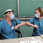 Family practice physician Christina Tuomi, DO, (right) elbow bumps with Emergency Department nurse Steve Hughes (left) after getting Homers first dose of Pfizers COVID-19 vaccine on Thursday, Dec. 17, 2020 at South Peninsula Hospital in Homer, Alaska. Tuomi has been the hospitals medical lead throughout the pandemic. (Photo courtesy Derotha Ferraro/South Peninsula Hospital)