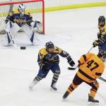 Homers Bergen Knutson (left) and Toby Nevak (right) try to fend off Dimonds Kaden Daniels during a Friday, Feb. 14, 2020 game at the 2020 ASAA First National Cup Division I Hockey State Championship at the Curtis D. Menard Memorial Sports Center in Wasilla, Alaska. (Photo by Megan Pacer/Homer News)