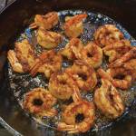 The recipe for warm chili shrimp salad with little gems and tomatoes starts with cooking the shrimp until golden brown, as seen here on Tuesday, Dec. 22, 2020, in the kitchen of her Homer, Alaska, home. (Photo by Teri Robl)