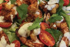 Warm chili shrimp salad with little gems and tomatoes makes a festive holiday dish with its Christmas red-and-green colors, as seen here on Tuesday, Dec. 22, 2020, in the kitchen of her Homer, Alaska, home. (Photo by Teri Robl)