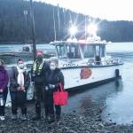 Curtis Jackson, second from right, poses on Thursday, Dec. 17, 2020, with SVT Health & Wellness Center health care workers in Jakolof Bay, Alaska, after making a trip across Kachemak Bay from Homer to deliver the medical team and Pfizer COVID-19 vaccine. From left to right are nurse Candice Kreger, family nurse practitioner Kourtney Holder, Jackson, and family nurse practitioner Julie Drude. The health care workers then went by road to Seldovia. (Photo by Janel Harris courtesy of Makos Water Taxi)