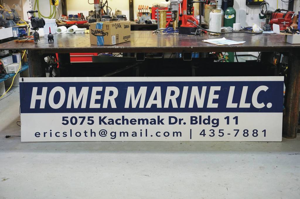 The new sign for Homer Marine is waiting to be installed on Thursday, Dec. 17, 2020, at the store in the Northern Enterprises Boatyard in Homer, Alaska. (Photo by Michael Armstrong/Homer News)