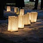 Memorial luminarias provide a somber light at Hospice of Homers Light Up a Life and 35th Anniversary Gathering last Friday, Dec. 18, 2020, at WKFL Park in Homer, Alaska. The event honored staff and volunteers who have helped out at the organization over the decades. As a fundraiser for hospice, people purchased luminarias to honor deceased friends and family. Luminarias are a Hispanic tradition where candles are placed in a paper bag weighed down with sand. Also known as farolitios, Catholics place luminarias to guide the spirit of the Christ child to ones home. (Photo by Michael Armstrong/Homer News)