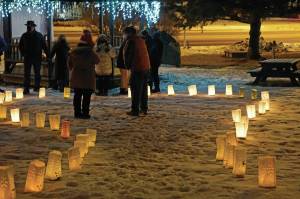 Memorial luminarias provide a somber light at Hospice of Homer's "Light Up a Life" and 35th Anniversary Gathering last Friday, Dec. 18, 2020, at WKFL Park in Homer, Alaska. The event honored staff and volunteers who have helped out at the organization over the decades. As a fundraiser for hospice, people purchased luminarias to honor deceased friends and family.
Luminarias are a Hispanic tradition where candles are placed in a paper bag weighed down with sand. Also known as farolitios, Catholics place luminarias to guide the spirit of the Christ child to one's home. (Photo by Michael Armstrong/Homer News)