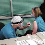 Family practice physician Christina Tuomi, D.O., (right) gets Homers first dose of Pfizers COVID-19 vaccine from Emergency Department nurse Steve Hughes (left) on Thursday, Dec. 17, 2020 at South Peninsula Hospital in Homer, Alaska. Tuomi has been the hospitals medical lead throughout the pandemic. (Photo courtesy Derotha Ferraro/South Peninsula Hospital)