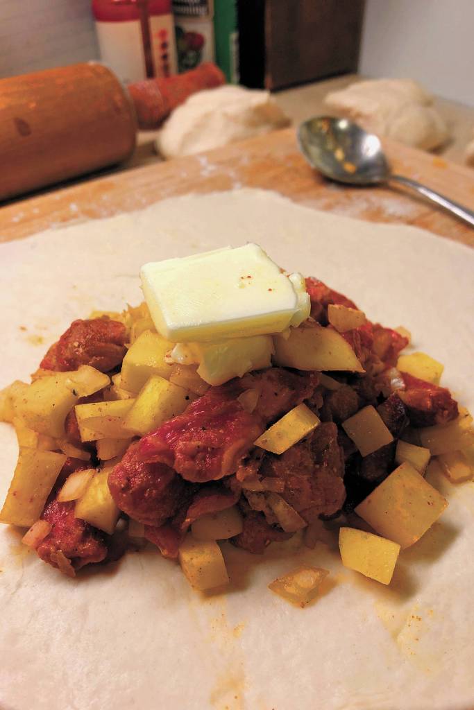 A dollop of butter or margarine on top of the filling before baking a pasty can never hurt, as seen here on Christmas Day, Dec. 25, 2020 in Crystal Falls, Michigan. (Photo by Megan Pacer/Homer News)