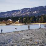 People walk the beach on the New Years Eve, Dec. 31, 2020, at Mariner Park on the Homer Spit in Homer, Alaska. (Photo by Michael Armstrong/Homer News)
