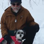 Michael Armstrong and his dog, Fletcher, take a break from snowshoeing on Sunday, Dec. 13, 2020, on Diamond Ridge near Homer, Alaska. (Photo by Jenny Stroyeck)