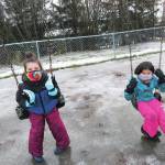 Students Sabriel Davidson and Kenadi Smith play on the swings on Monday, Jan. 11, 2021 at Fireweed Academy in Homer, Alaska. Elementary students were able to return to onsite schooling five days a week starting Monday. (Photo courtesy Todd Hindman/Fireweed Academy)