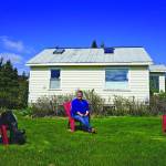 Pratt Museum officials pose for a photograph while practicing social distancing on the museum lawn on Friday, May 15, 2020, in Homer, Alaska. From left to right are Jennifer Gibbins, executive director; Savanna Bradley, curator, and Marilyn Sigman, naturalist in residence. (Photo by Michael Armstrong/Homer News)