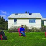 Pratt Museum officials pose for a photograph while practicing social distancing on the museum lawn on Friday, May 15, 2020, in Homer, Alaska. From left to right are Jennifer Gibbins, executive director; Savanna Bradley, curator, and Marilyn Sigman, naturalist in residence. (Photo by Michael Armstrong/Homer News)