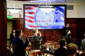 photo by James Brooks/Anchorage Daily News, Pool 
Members of the Alaska House of Representatives take their oaths of office on Tuesday, Jan. 19, in the Alaska State Capitol at Juneau. Members were allowed to remove their COVID-19 masks as they took the oath.