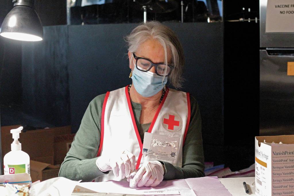 Health & Wellness Educator Bonita Banks, a nurse at South Peninsula Hospital, prepares to remove a dose of the Moderna vaccine from a vial Friday, Jan. 15, 2021 during a vaccination clinic for seniors put on by the hospital and the City of Homer at Christian Community Church in Homer, Alaska. (Photo by Megan Pacer/Homer News)