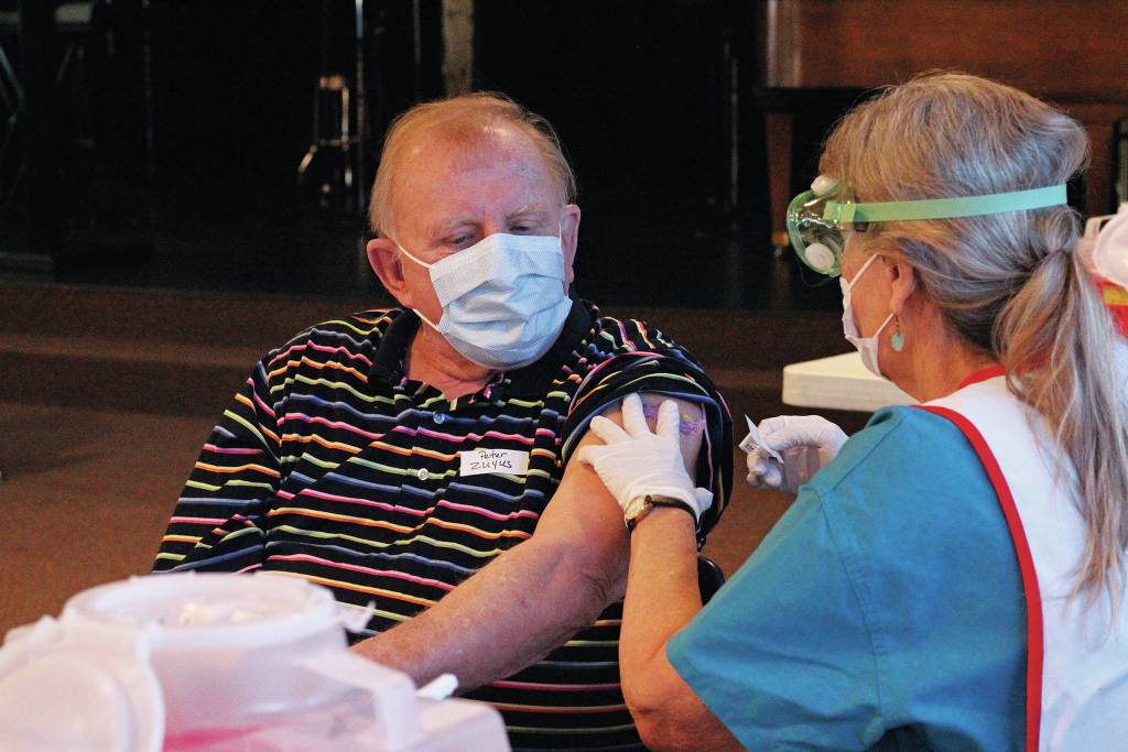 Peter Zuyus finishes getting his first dose of the Moderna vaccine Friday, Jan. 15, 2021 at a large-scale clinic put on by South Peninsula Hospital and the City of Homer at Christian Community Church in Homer, Alaska. The clinic was able to give 700 appointments to seniors, who were recently authorized to get the vaccine in Alaska. (Photo by Megan Pacer/Homer News)