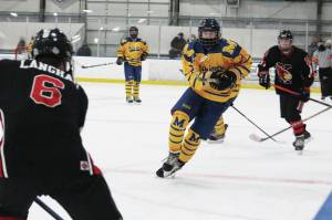 Homers Hunter Green looks for a way around Kenais Gavin Langham during a Friday, Jan. 22, 2021 hockey game between the two schools at Kevin Bell Arena in Homer, Alaska. (Photo by Megan Pacer/Homer News)